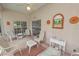 This screened porch features patio furniture, a decorative painting, and a ceiling fan at 2616 Fairmount Ave, Lakeland, FL 33803