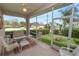 This screened porch features a ceiling fan, views of a green yard, and comfortable patio furniture at 2616 Fairmount Ave, Lakeland, FL 33803