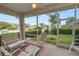 This screened porch features views of a green yard, outdoor furniture, and a ceiling fan at 2616 Fairmount Ave, Lakeland, FL 33803