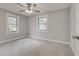 Bedroom featuring neutral colors, ceiling fan, and ample natural light from windows at 2638 Ralph Rd, Lakeland, FL 33801