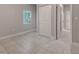 Well lit bedroom with tile flooring and a closet at 2638 Ralph Rd, Lakeland, FL 33801