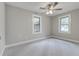 Bedroom featuring neutral colors, ceiling fan, and ample natural light from double windows at 2638 Ralph Rd, Lakeland, FL 33801