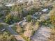 Bird's-eye view of home with lush foliage, neighborhood, and cleared lot at 2714 Golfview St, Lakeland, FL 33801