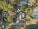 Bird's-eye view of home showcasing lush trees, driveway, and neighborhood street, creating a serene atmosphere at 2714 Golfview St, Lakeland, FL 33801