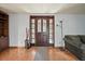 Inviting entryway featuring a solid wood door with decorative glass, light fixture, and tiled floor at 2714 Golfview St, Lakeland, FL 33801