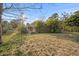 Single-story home featuring a charming front porch, mature trees, and a well-maintained lawn at 2714 Golfview St, Lakeland, FL 33801