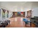 Spacious living room featuring tiled floors, a stone fireplace, and access to the outdoors at 2714 Golfview St, Lakeland, FL 33801