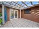 Private outdoor patio featuring tiled flooring, a white pergola, and a tranquil backyard view at 2714 Golfview St, Lakeland, FL 33801