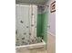 Bathroom features a shower/tub combination with green tile and a butterfly-themed shower curtain at 3023 Maplewood Ave, Lakeland, FL 33803