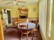 Cozy dining area with a round table, wooden chairs, and natural light from the window at 3023 Maplewood Ave, Lakeland, FL 33803