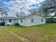 Exterior view of home with a well-maintained yard, showcasing a simple and clean backyard at 3023 Maplewood Ave, Lakeland, FL 33803