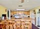 Spacious kitchen featuring a breakfast bar with wooden stools, wood cabinets, and white appliances at 3023 Maplewood Ave, Lakeland, FL 33803