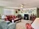 Cozy living room with carpet flooring, ceiling fan, and decorative shelving highlighting personal touches at 3023 Maplewood Ave, Lakeland, FL 33803