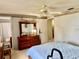 Spacious main bedroom with a ceiling fan, dresser, and ensuite bathroom access for convenience at 3023 Maplewood Ave, Lakeland, FL 33803