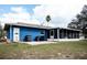 View of the home's backyard with a screened in patio at 304 Olmo Ct, Winter Haven, FL 33880