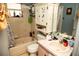 Modest bathroom features a vanity with a sink, medicine cabinet and a bath tub at 304 Olmo Ct, Winter Haven, FL 33880