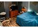 Dark bedroom featuring wood floors, a dresser, and a queen bed at 304 Olmo Ct, Winter Haven, FL 33880