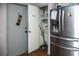 Kitchen pantry with storage space and stainless steel refrigerator at 304 Olmo Ct, Winter Haven, FL 33880