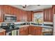 Well-lit kitchen featuring stainless steel appliances and dark wood cabinetry at 3207 S Polk Ave, Lakeland, FL 33803