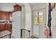 View of the kitchen with stainless steel appliances, dark wood cabinets, and an exterior door at 3207 S Polk Ave, Lakeland, FL 33803