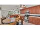 Spacious eat-in kitchen featuring tile floors, wooden cabinets, and stainless steel appliances at 3207 S Polk Ave, Lakeland, FL 33803