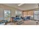 Relaxing sunroom with cozy seating, neutral tones, and views of the well-maintained yard through large windows at 3207 S Polk Ave, Lakeland, FL 33803