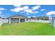 The home has a large backyard, view of covered patio, and white fence at 3224 Pearly Dr, Lakeland, FL 33812