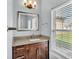 Bathroom sink with granite countertops, wood cabinets, and a large window at 3224 Pearly Dr, Lakeland, FL 33812