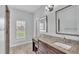 Bathroom vanity with granite countertops, wood cabinets, and sink with tiled shower at 3224 Pearly Dr, Lakeland, FL 33812