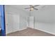 Bedroom featuring neutral carpet, ceiling fan, and closet with a connected bathroom through an open door at 3224 Pearly Dr, Lakeland, FL 33812