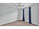 Bedroom featuring neutral carpet, a ceiling fan, and a window offering natural light at 3224 Pearly Dr, Lakeland, FL 33812