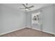 Clean bedroom featuring carpeted floors, ceiling fan, window with view of the outdoors, and light blue walls at 3224 Pearly Dr, Lakeland, FL 33812