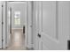 Hallway with tile flooring, natural light, and white doors at 3224 Pearly Dr, Lakeland, FL 33812