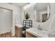 Bright bathroom featuring double sinks, stylish wood cabinets, and decorative mirror at 3328 Imperial Ln, Lakeland, FL 33812