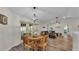 Charming dining area with a round wooden table, seating for four, and views of the backyard through French doors at 3328 Imperial Ln, Lakeland, FL 33812