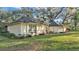 Exterior of the house with a green lawn, mature landscaping, and a home featuring a neutral color palette at 3328 Imperial Ln, Lakeland, FL 33812