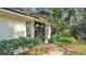 Beautiful front door with a landscaped entrance, mature plants, and windows on either side at 3328 Imperial Ln, Lakeland, FL 33812