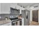 Kitchen featuring modern appliances, white cabinets, stylish backsplash, and updated countertops at 3328 Imperial Ln, Lakeland, FL 33812