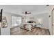 Serene main bedroom with a ceiling fan, natural light, and neutral décor to create a restful retreat at 3328 Imperial Ln, Lakeland, FL 33812