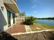 Inviting patio area with a view of the lush landscaping and serene lake creates a perfect outdoor retreat at 3350 Kilmer Dr, Lakeland, FL 33803