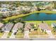 Overhead shot featuring a home with a backyard bordering a community pond and surrounded by lush greenery at 3882 Rollingsford Cir, Lakeland, FL 33810