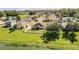 Aerial view of a well-maintained backyard with an umbrella and white fence, backing onto a serene pond at 3882 Rollingsford Cir, Lakeland, FL 33810