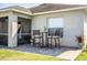 Charming backyard patio area with dining set and exterior view of the house at 3882 Rollingsford Cir, Lakeland, FL 33810