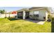 View of the backyard showcasing a screened patio, outdoor seating, and a seamlessly connected lush lawn at 3882 Rollingsford Cir, Lakeland, FL 33810