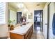 Well-lit bathroom with double sinks, vanity mirror, and an adjacent bedroom at 3882 Rollingsford Cir, Lakeland, FL 33810