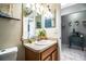 Well-lit bathroom features a single sink vanity with decorative elements and a separate toilet room at 3882 Rollingsford Cir, Lakeland, FL 33810