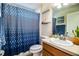 Bathroom featuring a vanity and a blue diamond patterned shower curtain at 3882 Rollingsford Cir, Lakeland, FL 33810