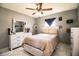 Comfortable bedroom includes a bed, dresser, and a ceiling fan at 3882 Rollingsford Cir, Lakeland, FL 33810