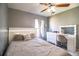 Bright bedroom includes a bed, vanity, desk, and ceiling fan at 3882 Rollingsford Cir, Lakeland, FL 33810