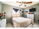 Bright bedroom includes a bed, dresser, and a ceiling fan at 3882 Rollingsford Cir, Lakeland, FL 33810